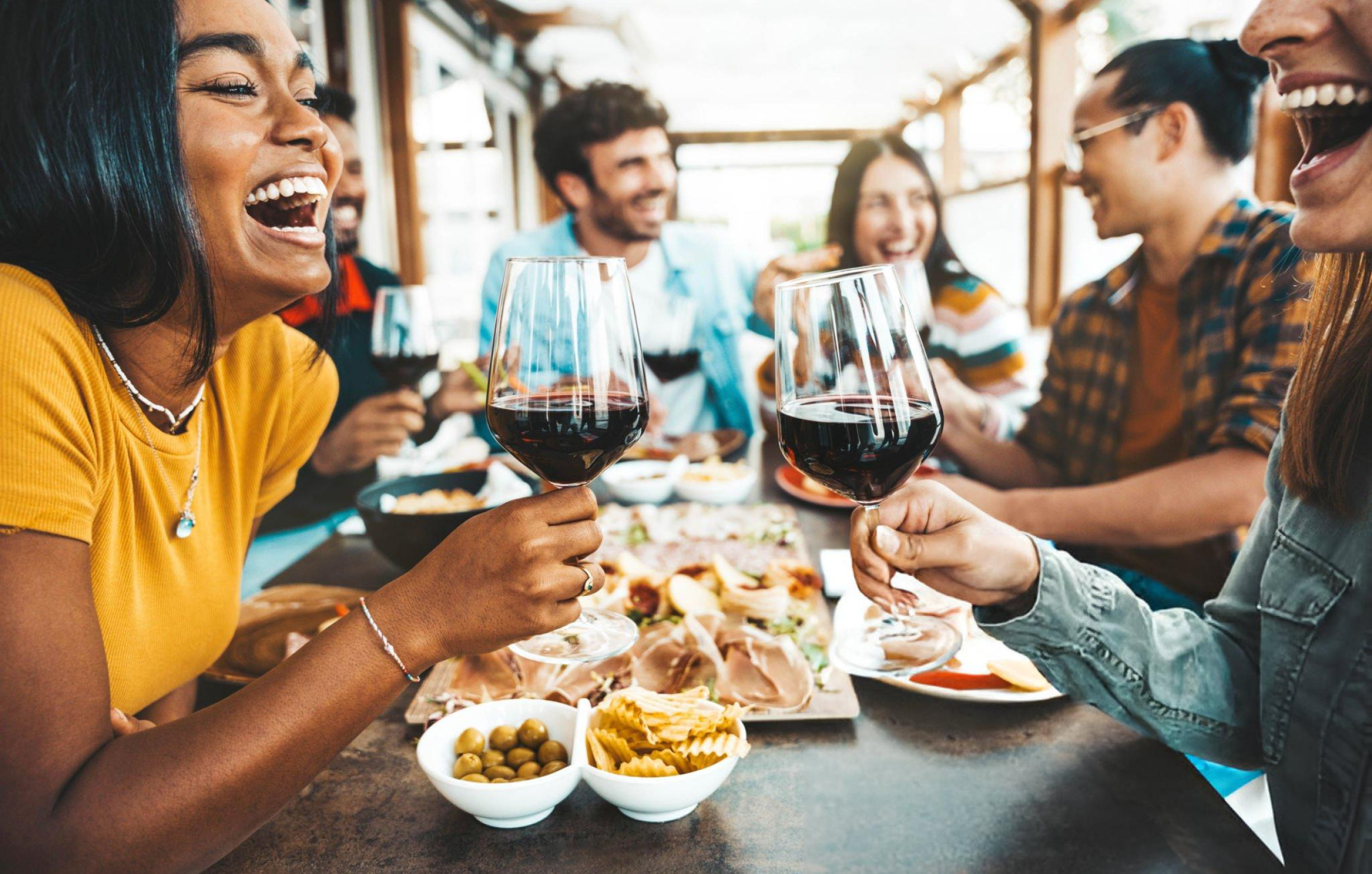 Group of friends toasting with wine at a restaurant